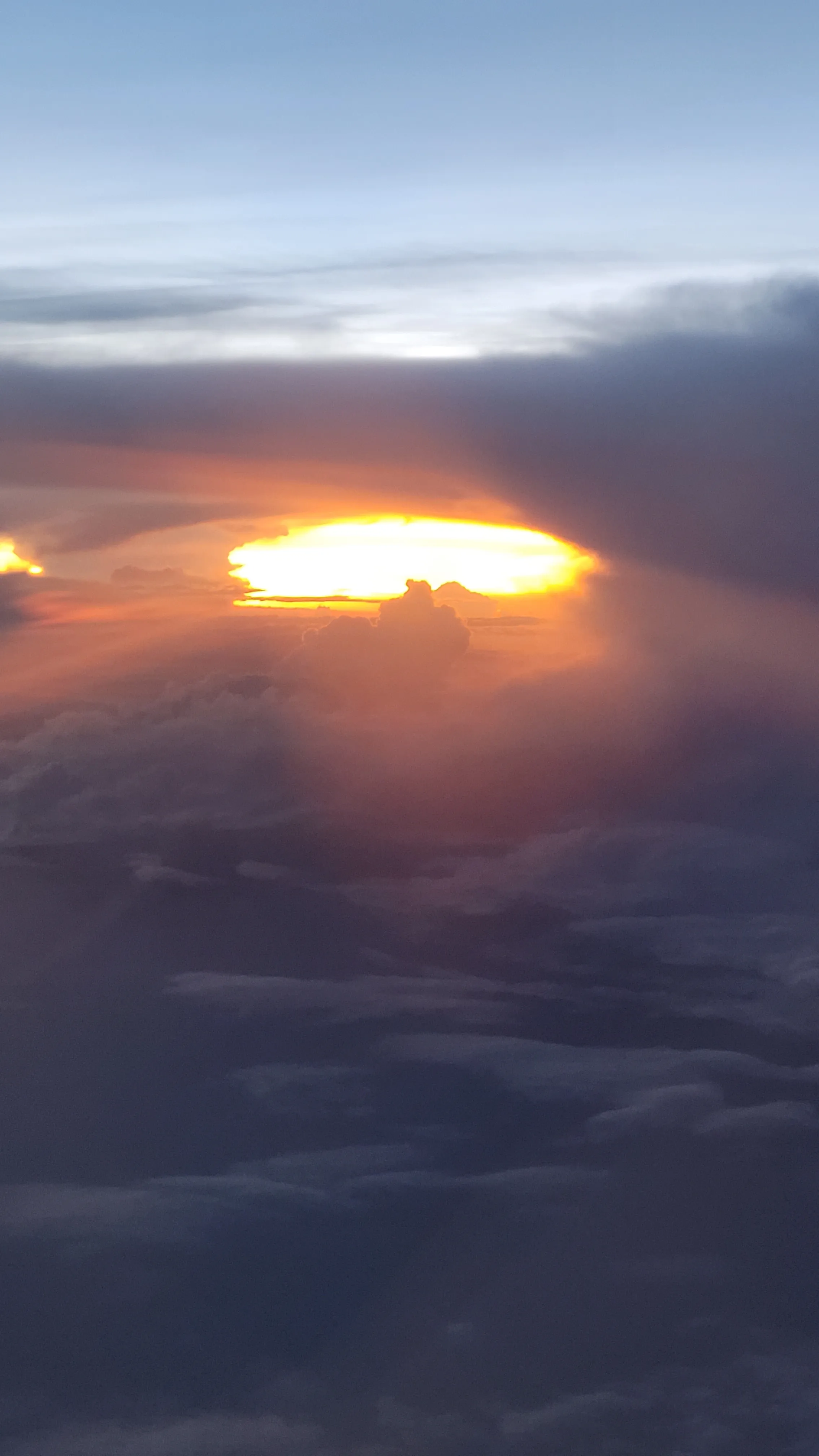 Bright sunburst behind dark clouds